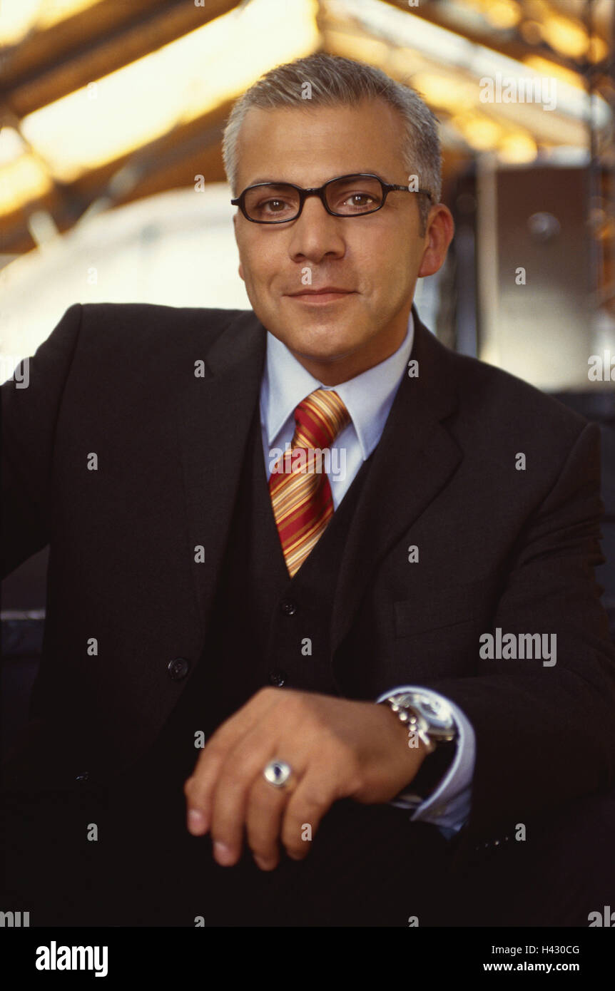 Office, businessman, half portrait, business, occupation, work, manager, manager, sollicitor, entrepreneur, office worker, man, glasses, grey-haired, suit, side glance, is relaxing, friendly, sympathetically, calmly, confidently, successfully, positive mo Stock Photo