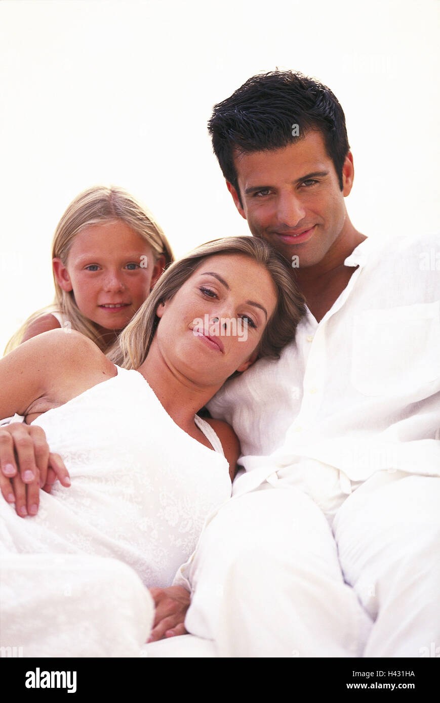 Parents, daughter, happily, relaxen   Family, family portrait, family picture, family luck, 20-30 years, 8 years, clothing, harmony, knows serenity, contentment recuperation relaxation, cuddles, nestles, leisure time, gaze camera, Stock Photo
