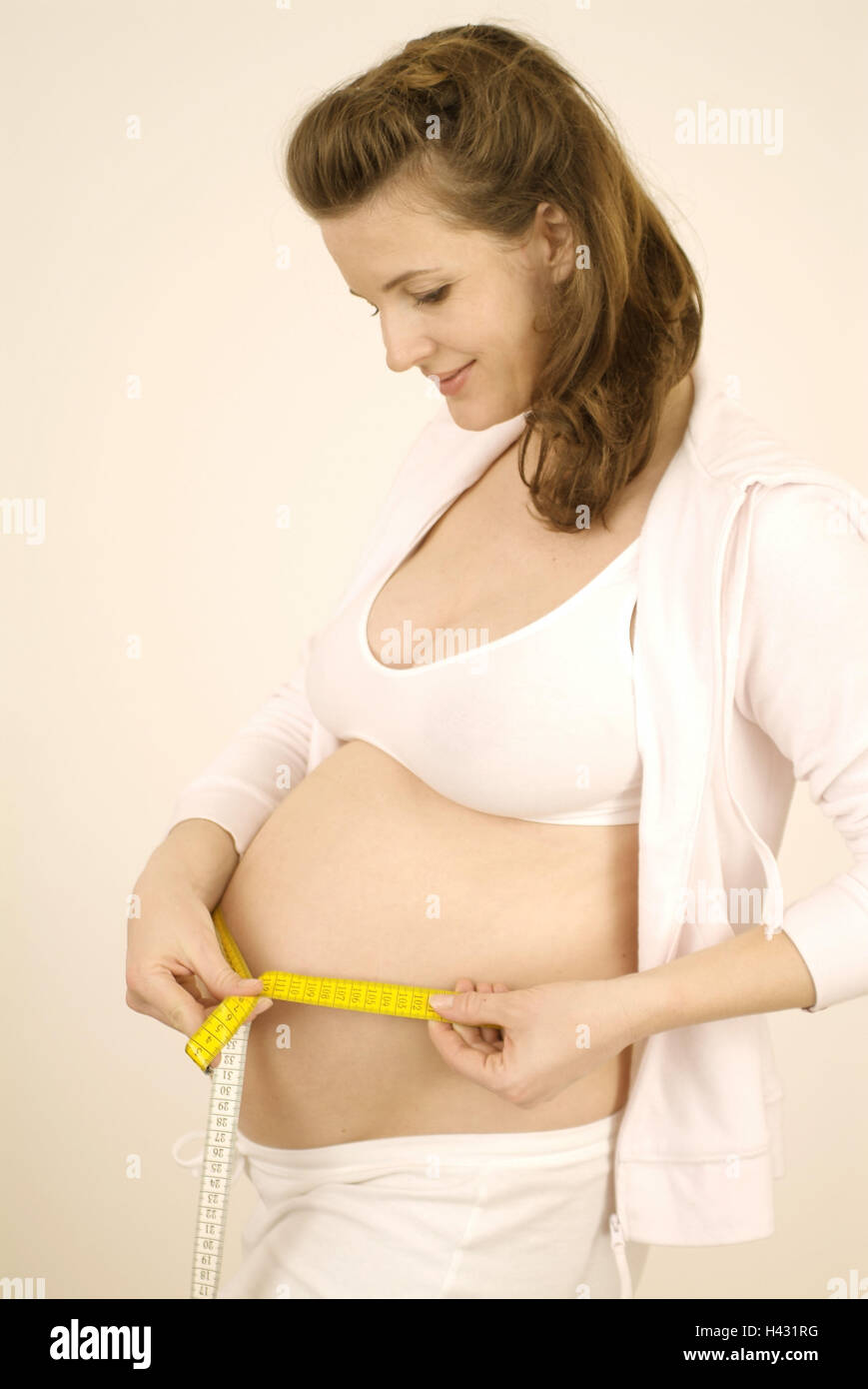 Woman, smile pregnant, abdomen, tape measure, side view, Gestation, gestation, 25 - 35 years, pregnant, gestation, baby abdomen, abdominal perimetre, measure, measure, weight, body weight, increase in weight, naturalness, happy, joy, pride, prejoy, balanc Stock Photo