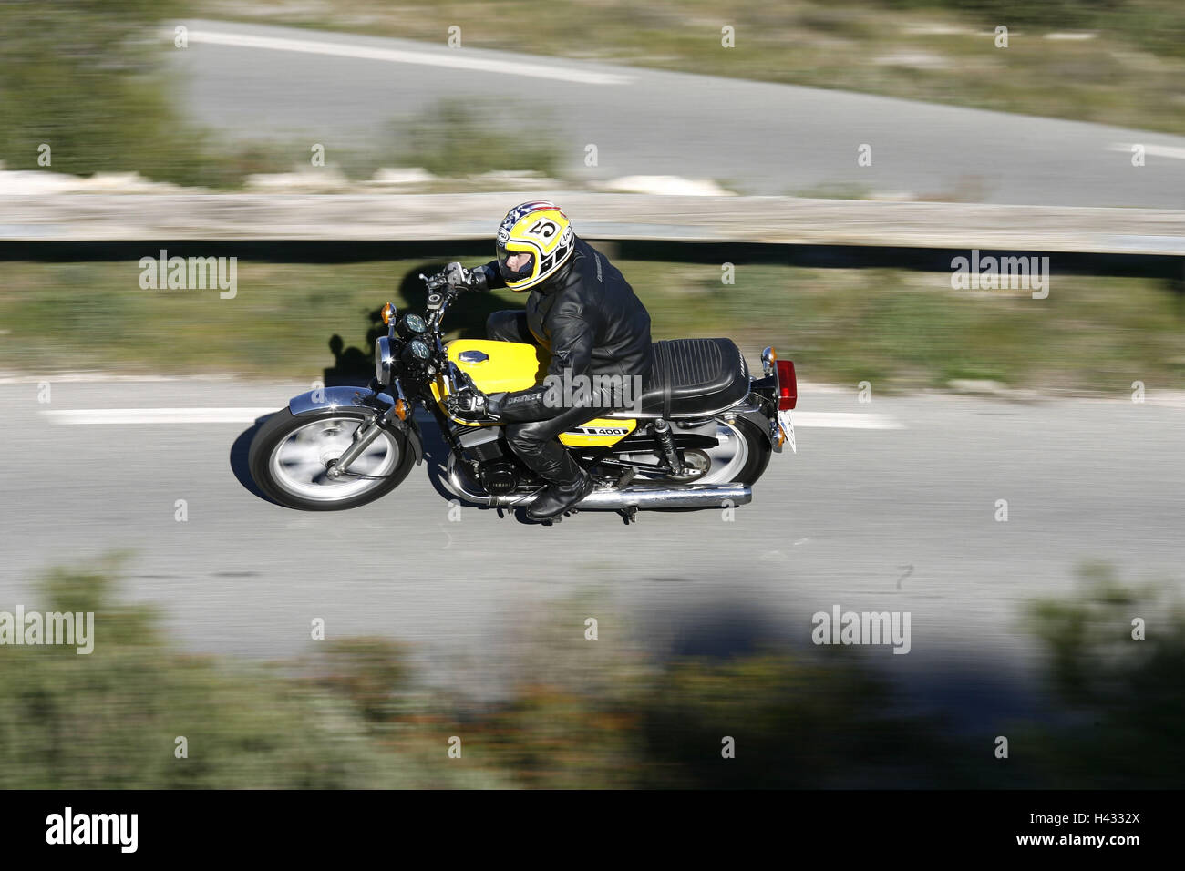 Motorcycle, Yamaha 'RD 400', yellow, moving, panning, from above Stock Photo