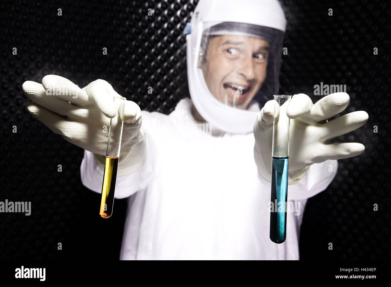 Researcher, joyfully. Protective suit, helmet, test tubes, hold, model