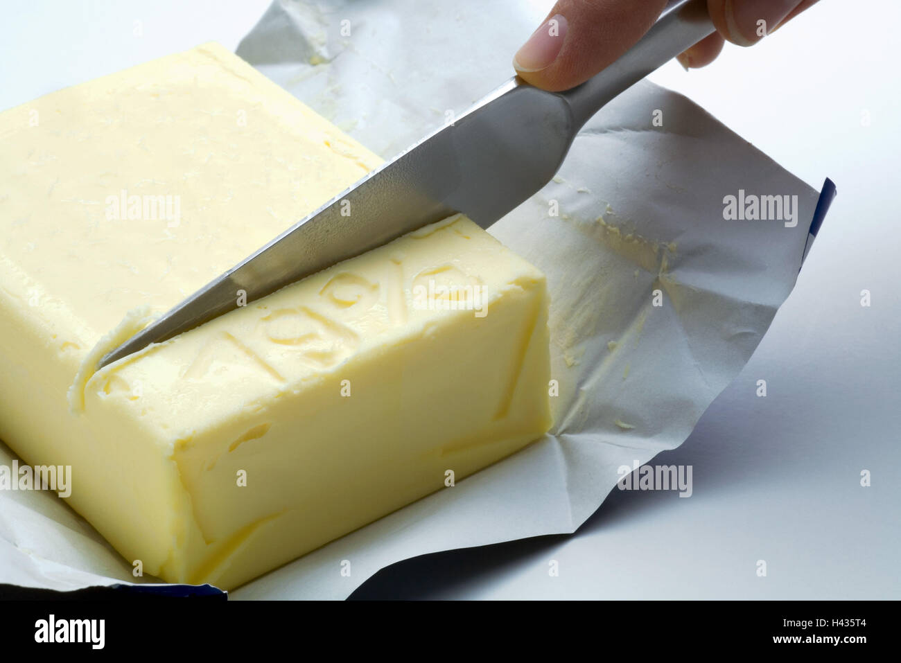 Person, knives, butter, part, 19 percent, cuts off, broached, buying power, symbol, buying power-decrease, depreciation, decrease, food, concept, effect, value added tax-increase, taxes, tax office, value added tax, surcharge, lapel, economy, finances, ta Stock Photo