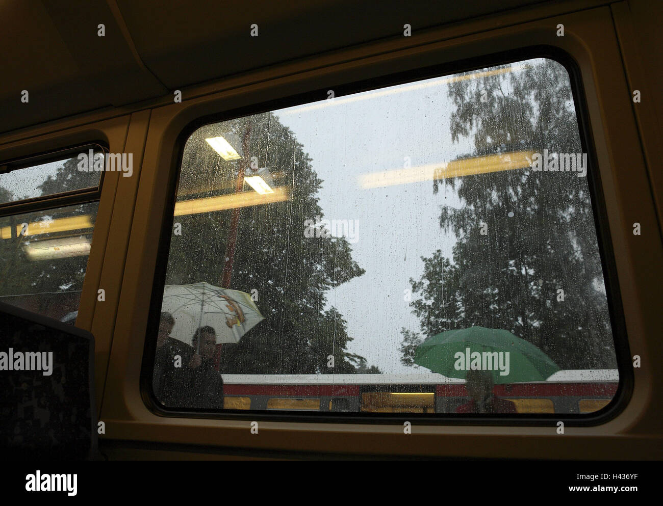 Railway station, train, view, window, person, umbrellas, detail