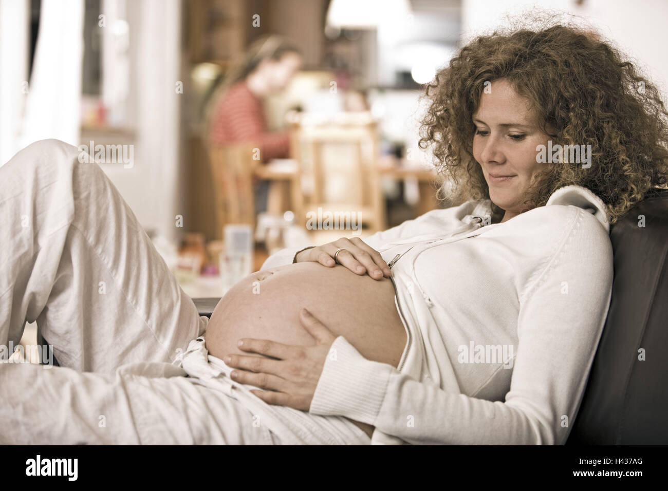 Woman, lie pregnant, sofa, relaxation Stock Photo Alamy
