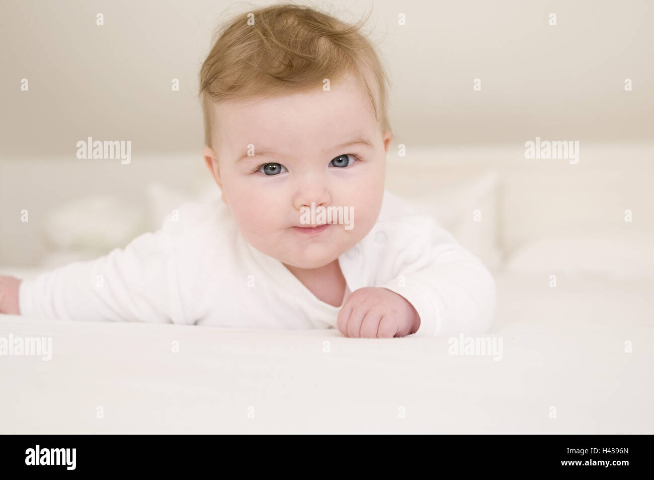 Baby, smile, abdominal position, bed, portrait Stock Photo Alamy