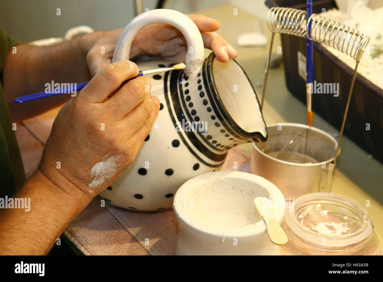 Potter garage, man, ceramics jug, restore, detail, hands, people, man's hands, jug, ceramics, broken, mend, repair, skill, manual labour, craftsmen, ceramics restoration, inside, Stock Photo