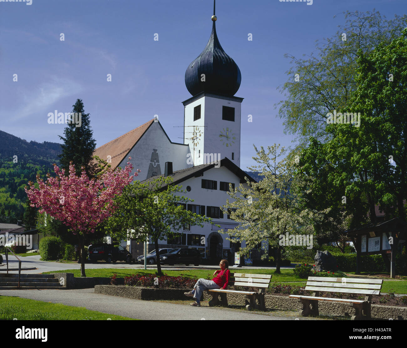 Germany, Upper Bavaria, bath Brook Feiln, Church, Park-benches, Spring, Tourist, South Germany, Bavaria, place, church, sacred construction, building, structure, architecture, faith, religion, Christianity, steeple, bulbous spire, trees, blossom, people, Stock Photo