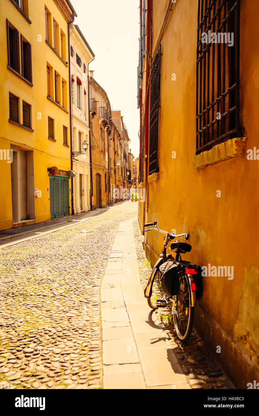 Bicycle leaning in building near street, Bologna, Emilia-Romagna, Italy Stock Photo