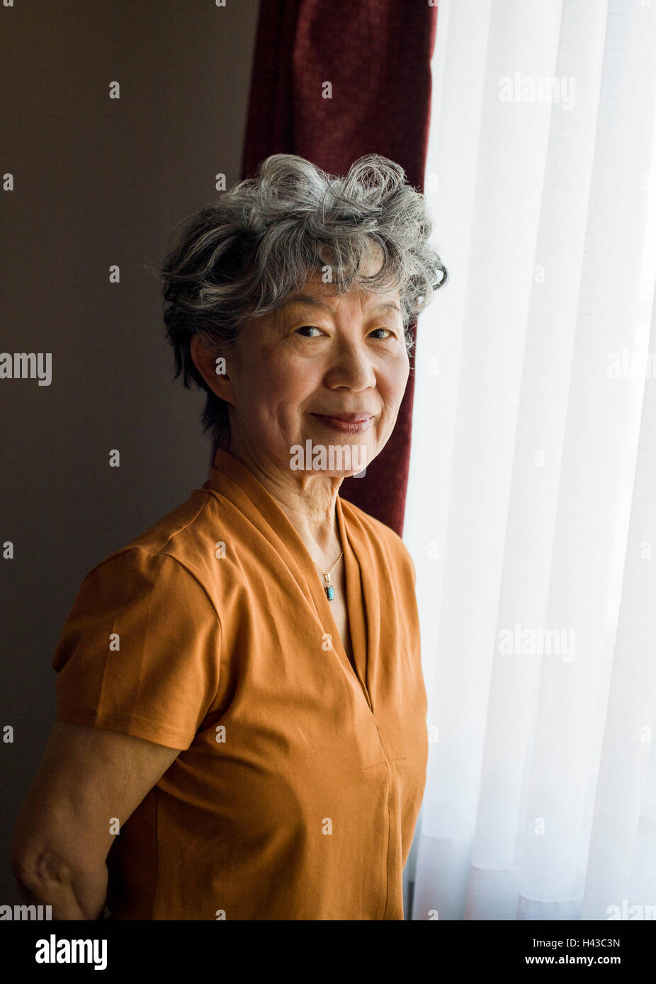 Smiling japanese woman standing hi-res stock photography and images - Alamy
