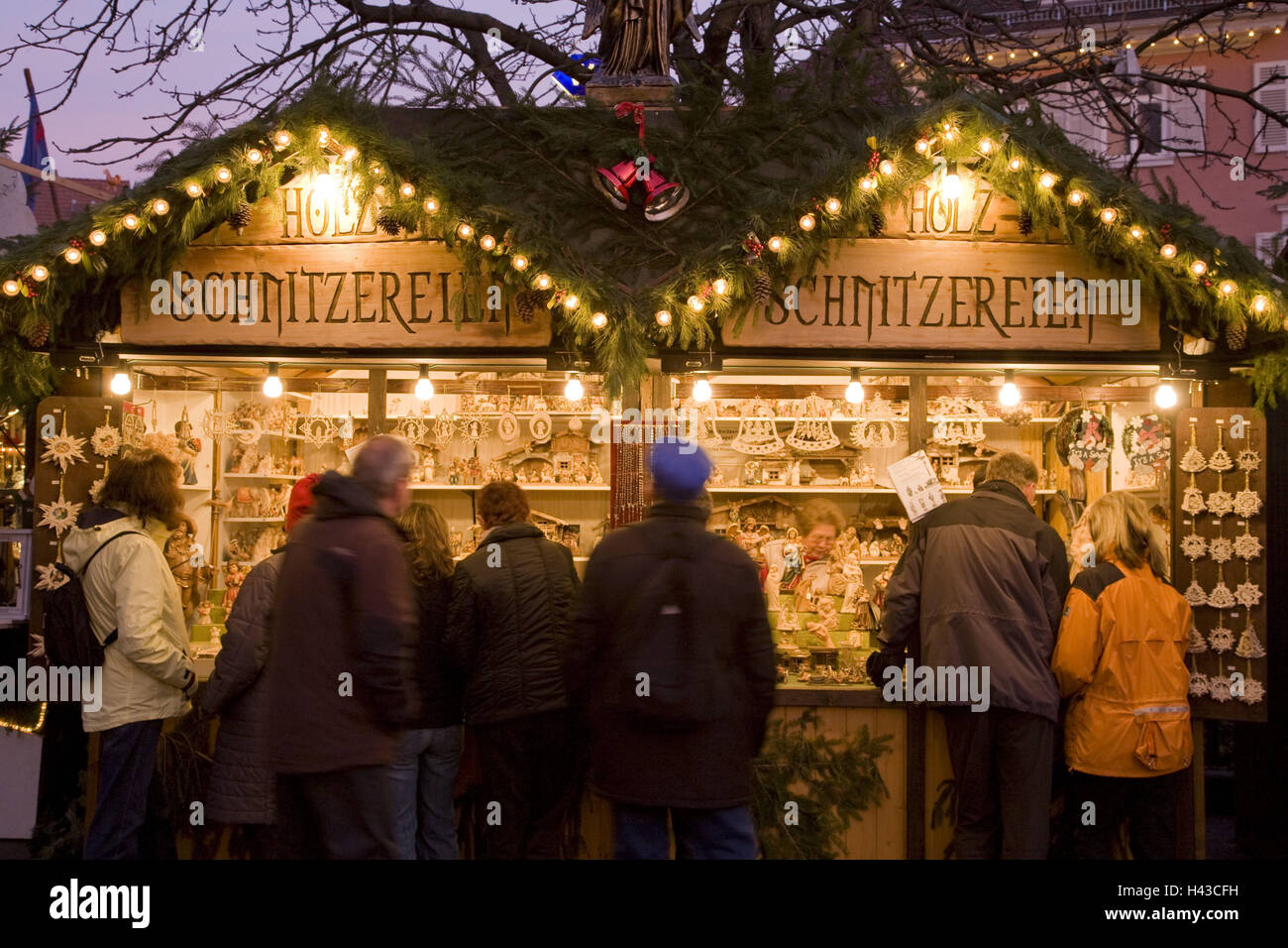 Germany, Baden-Wurttemberg, Esslingen, Christmas fair, market stall, wooden carvings, evening, Stock Photo