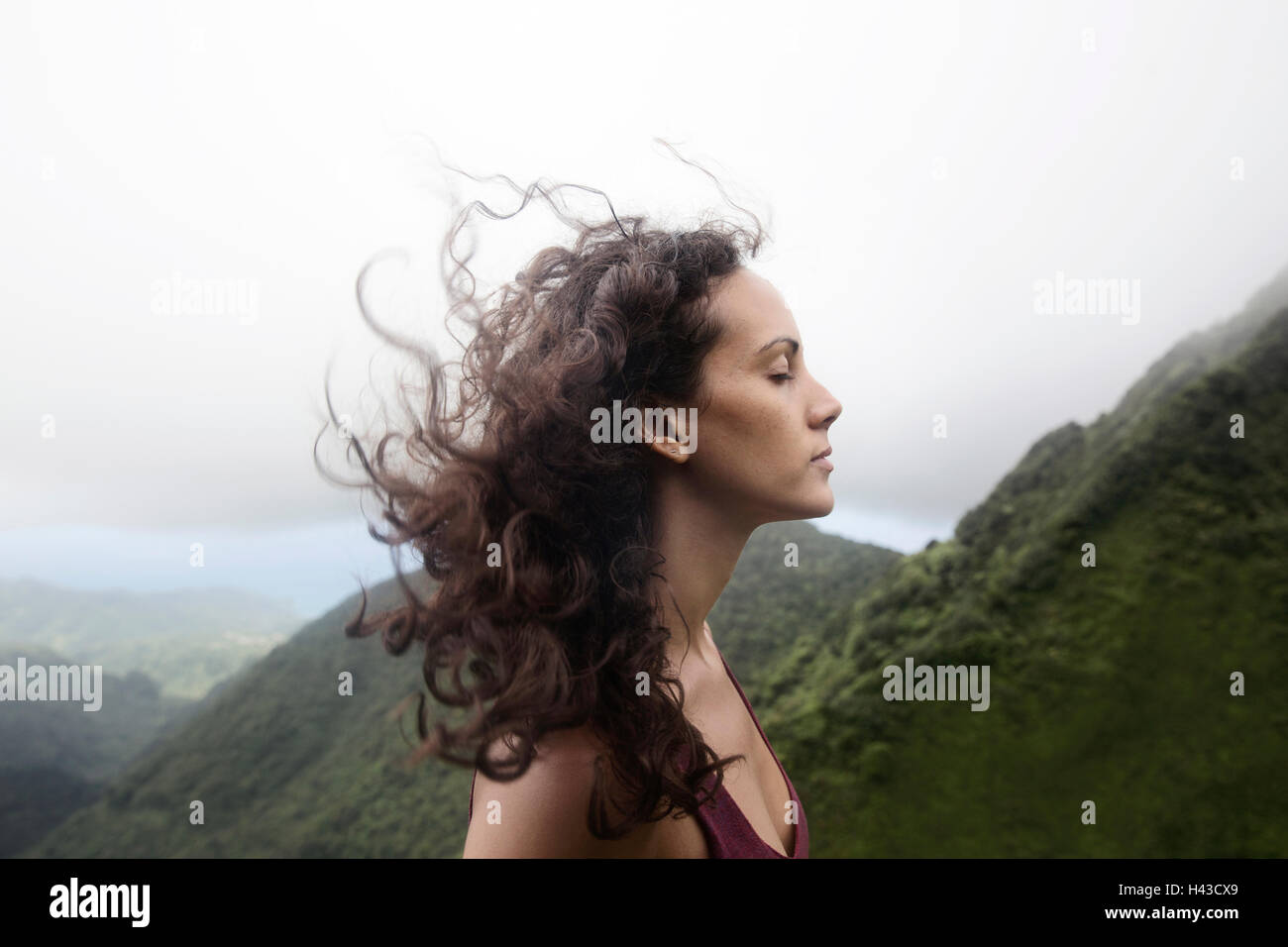Wind blowing hair of Mixed Race woman Stock Photo