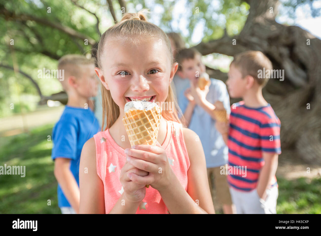 Caucasian girl eating ice cream cone Stock Photo