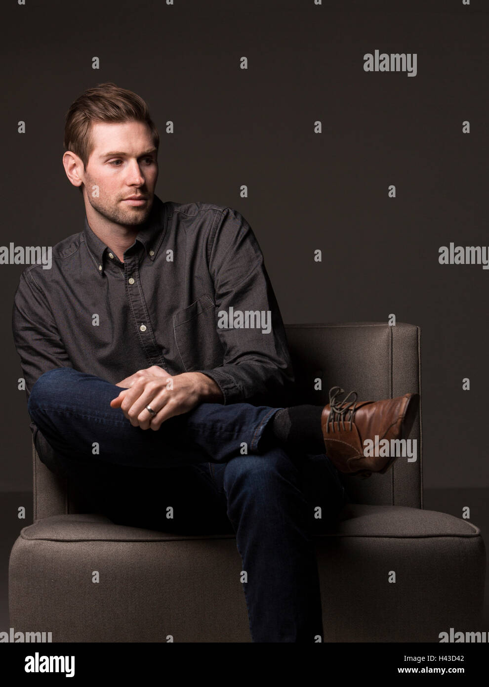 Man sitting chair studio shot hi-res stock photography and images - Alamy