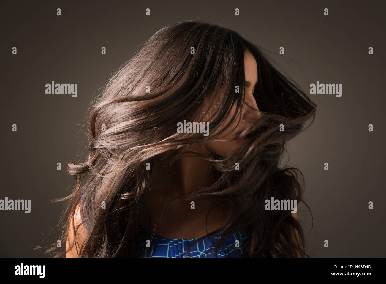 Mixed Race woman tossing hair Stock Photo