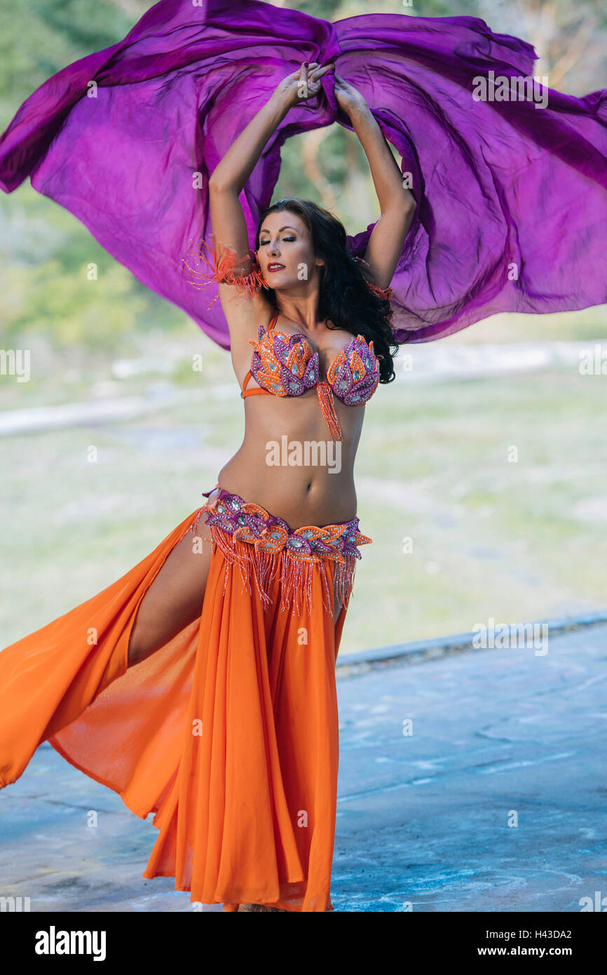 Belly dancer with arms raised Stock Photo