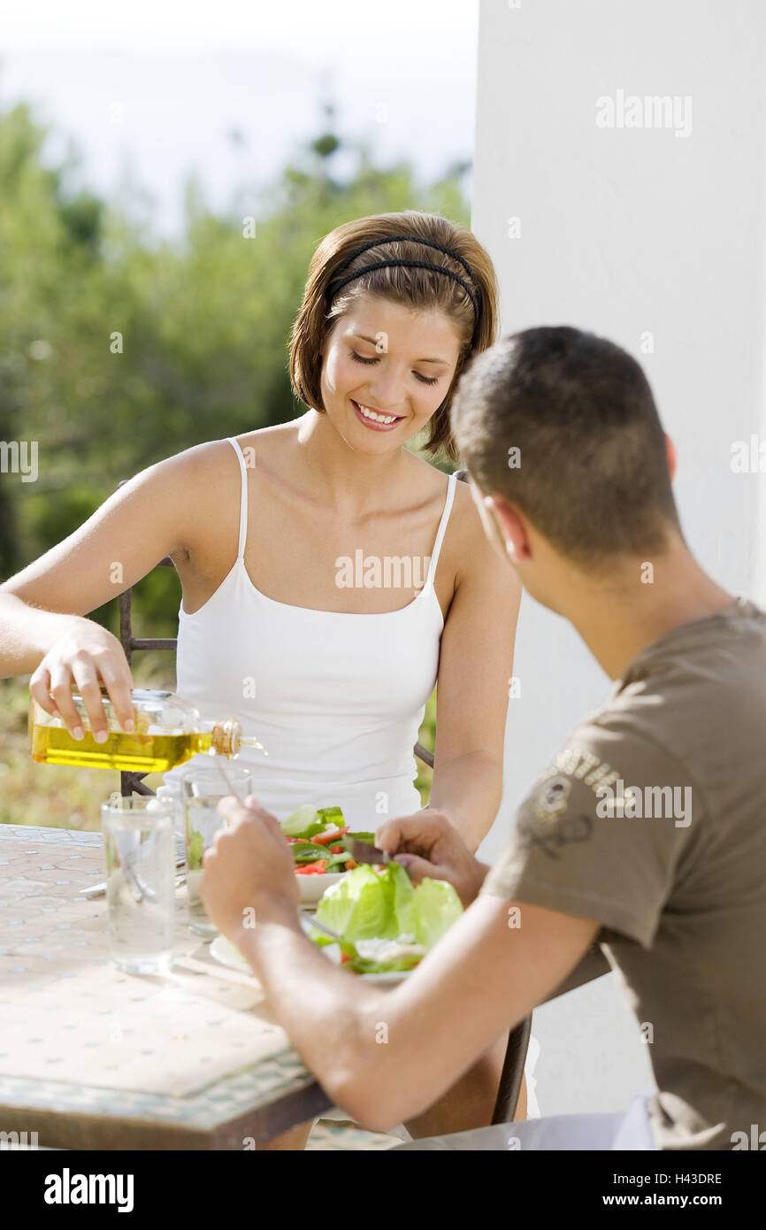 Couple, sit young, table, salad, olive oil, blur, model released Stock ...