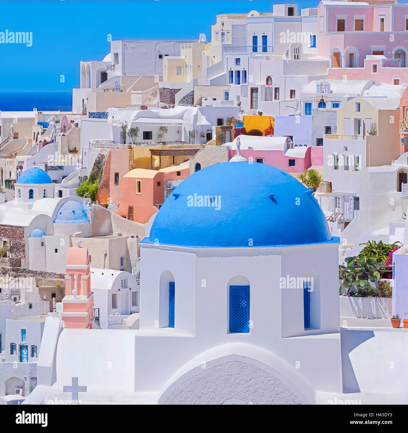 Orthodox church and colorful houses, Oia, Santorini, Cyclades Islands, Greece Stock Photo