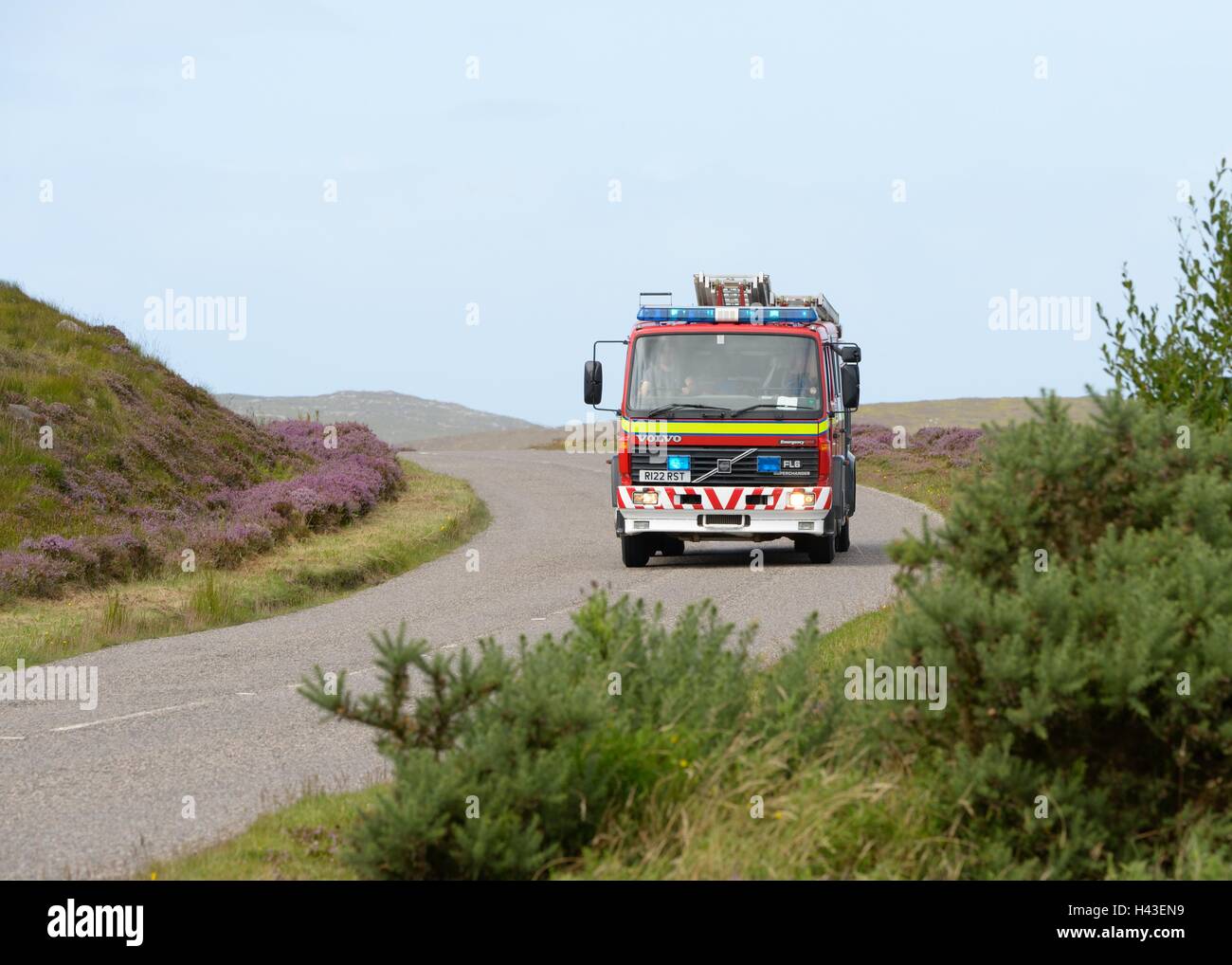 A fire appliance responding to an emergency call in the Scottish Highlands. Stock Photo