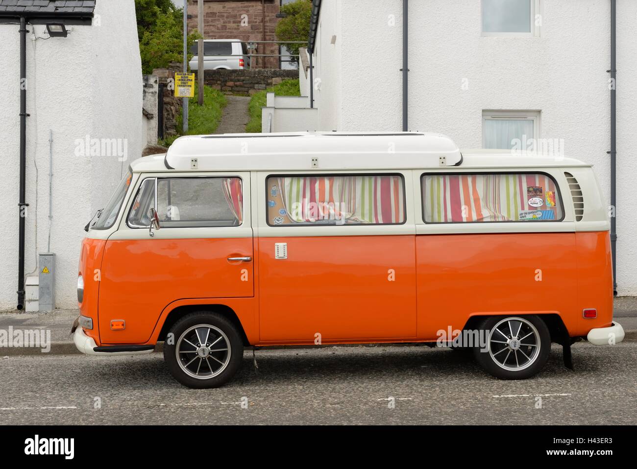 Orange Volkswagen camper van in Scotland, UK. Stock Photo