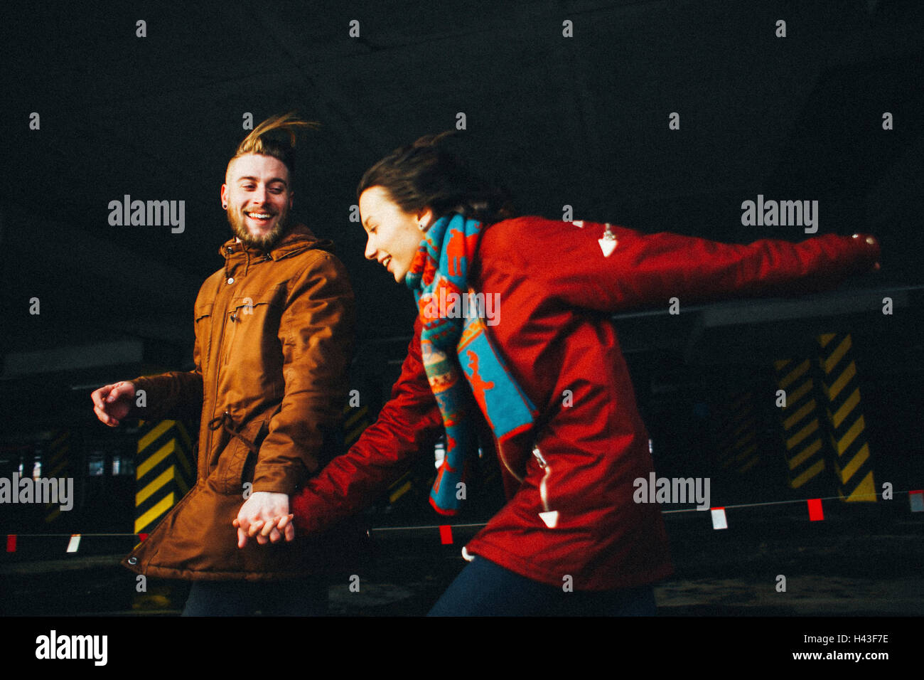 Caucasian couple running in wind Stock Photo Alamy