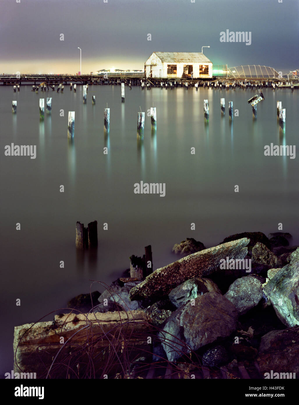 Pillars in still water at night Stock Photo