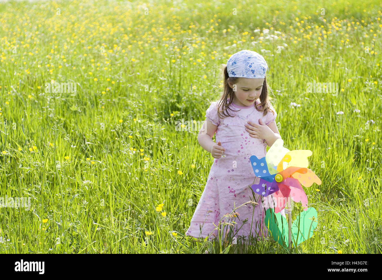 Girls, flower meadow, wind turbine, Stock Photo
