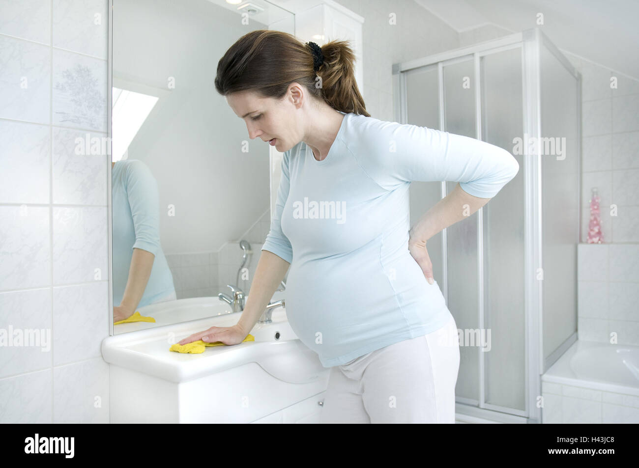 Woman, young, pregnant, bathrooms, clean, strain, model released Stock Photo Alamy