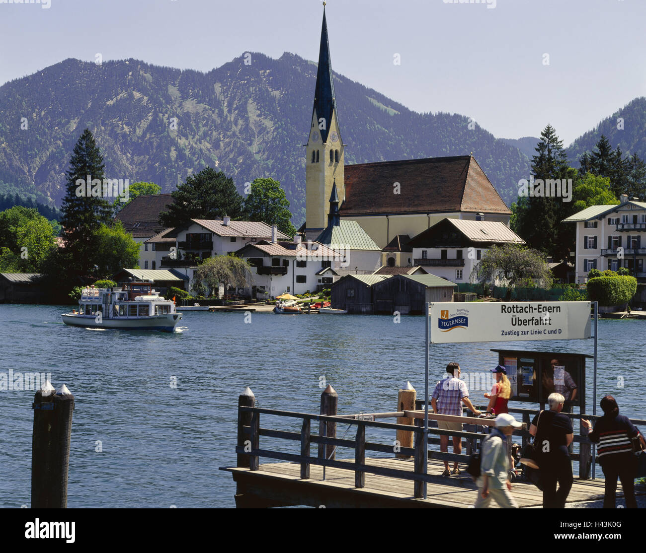 Germany, Upper Bavaria, to Rottach-Egern, landing stage, tourists, Tegernsee, South Germany, Bavaria, destination, place of interest, tourist attraction, boat trip, boat excursion, boat investor, bridge, wooden jetty, landing stage, building, church, stee Stock Photo