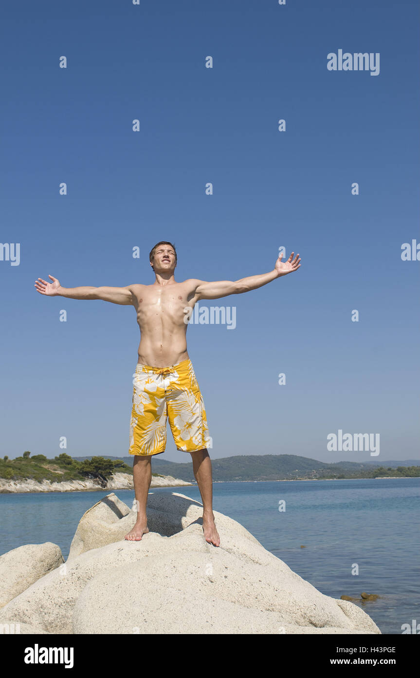 Man, arms spread, rocks, stand, Stock Photo