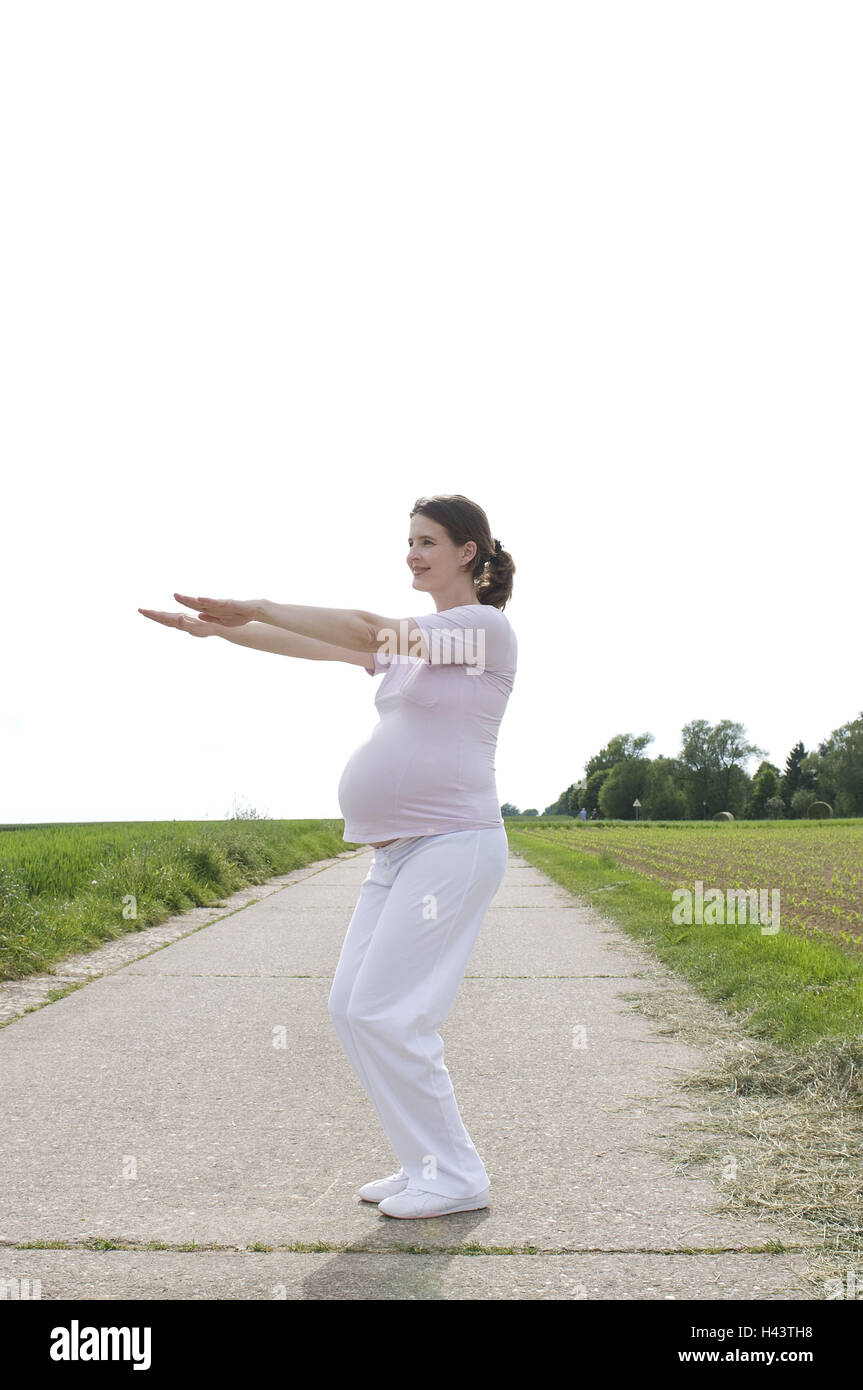 Woman, pregnant, gymnastics practise, outside Stock Photo Alamy