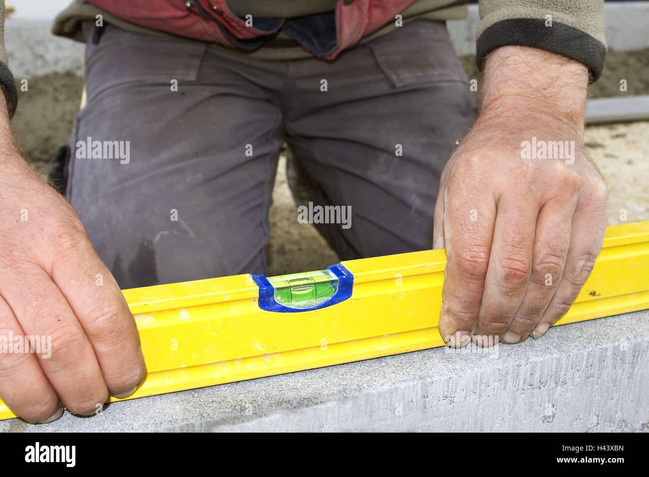 Construction workers, kneel, build level, precision work, model