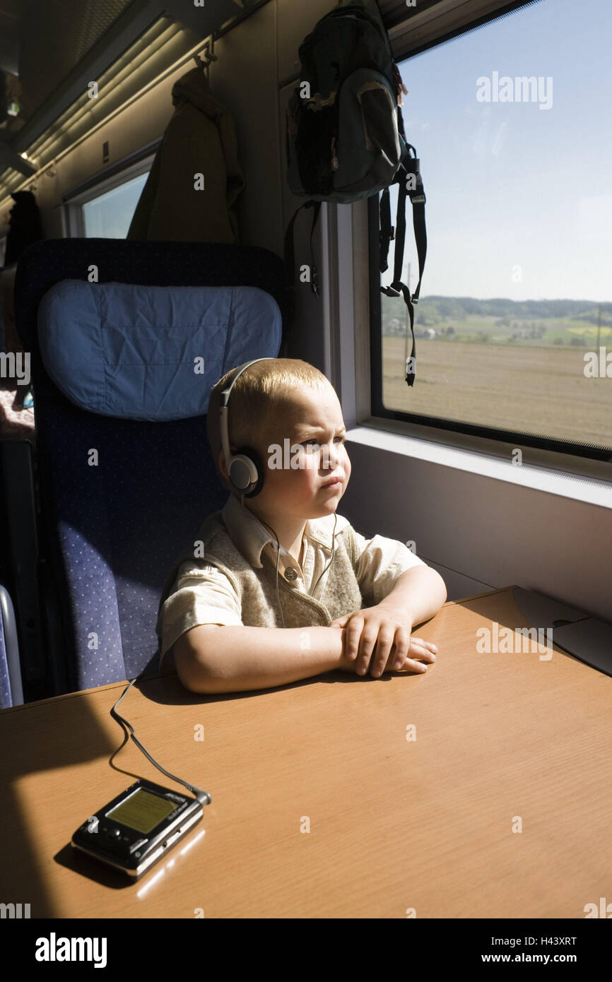 Train, child, earphone, seriously, people, boy, blond, MP3 player, music  hearing, music, hear, radio play, listen, activity, boredom, pastime,  thoughtful, train journey, train journey, train journey, to train travel,  go away, travel,