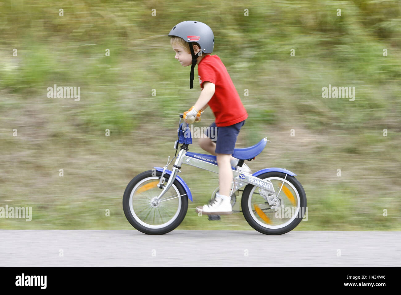Child, boy, bicycle driving, person, infant, helmet, riding of a bike,  bicycle, children's bicycle, two-wheeled vehicle, fun, activity, activity,  play, concentration, helped to pull Stock Photo - Alamy