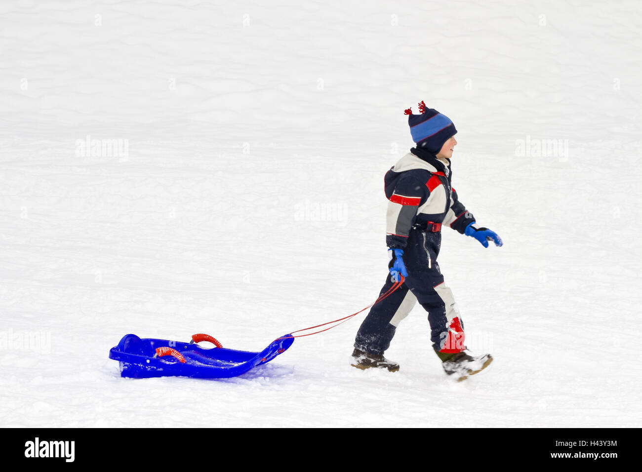 A boy, 6 years, in the snow suit, with the sledge, Bob, drag, go, side view, actively, activity, outside, motion, joy, season, child, boy, manly, plastic, person, sledges, toboggan, sledge fun, slide, snow, snow suit, fun, weather, winter, winter holidays Stock Photo