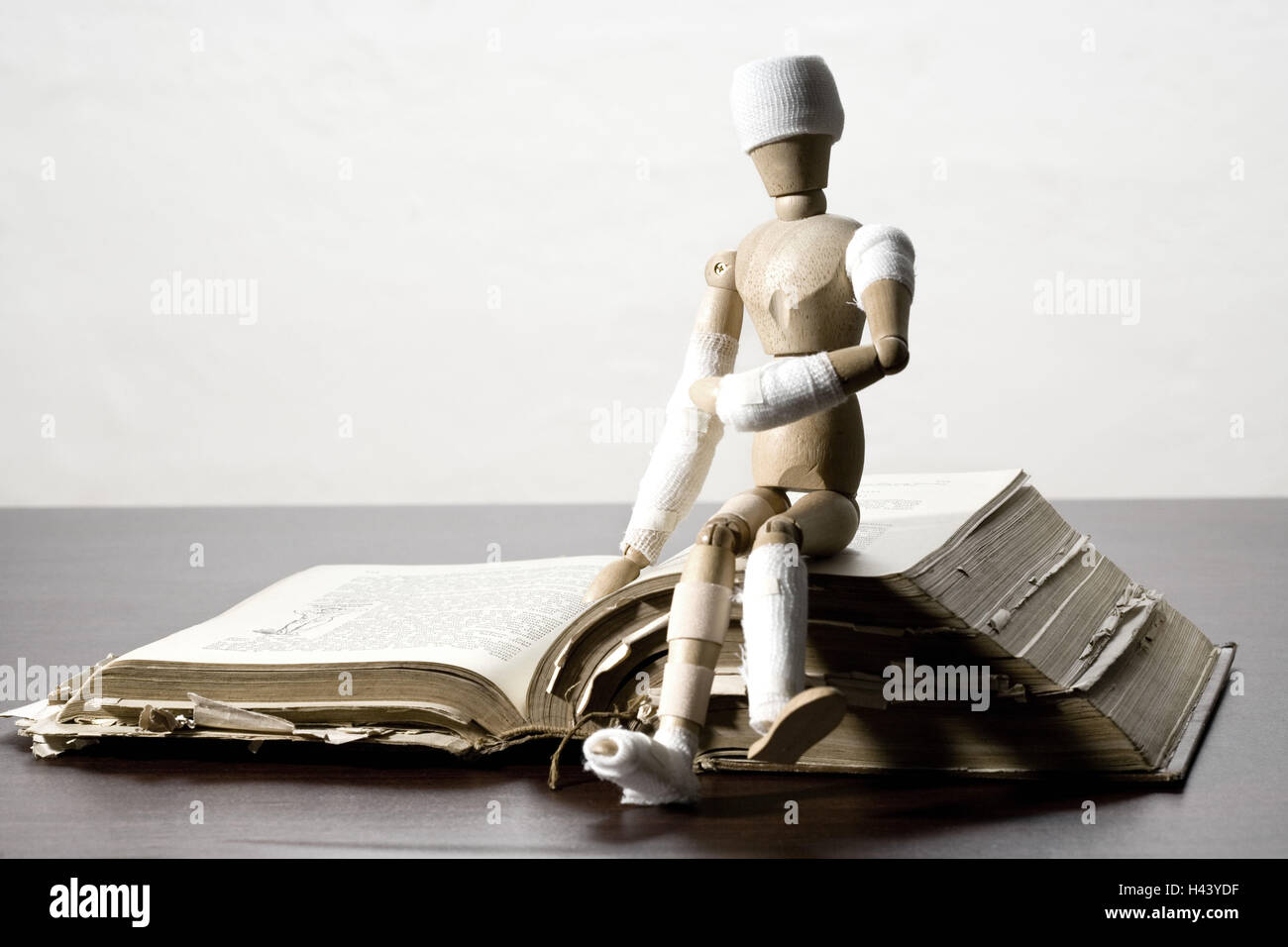Manikin, bandages, symbol, injury, book, old, sitting, Stock Photo