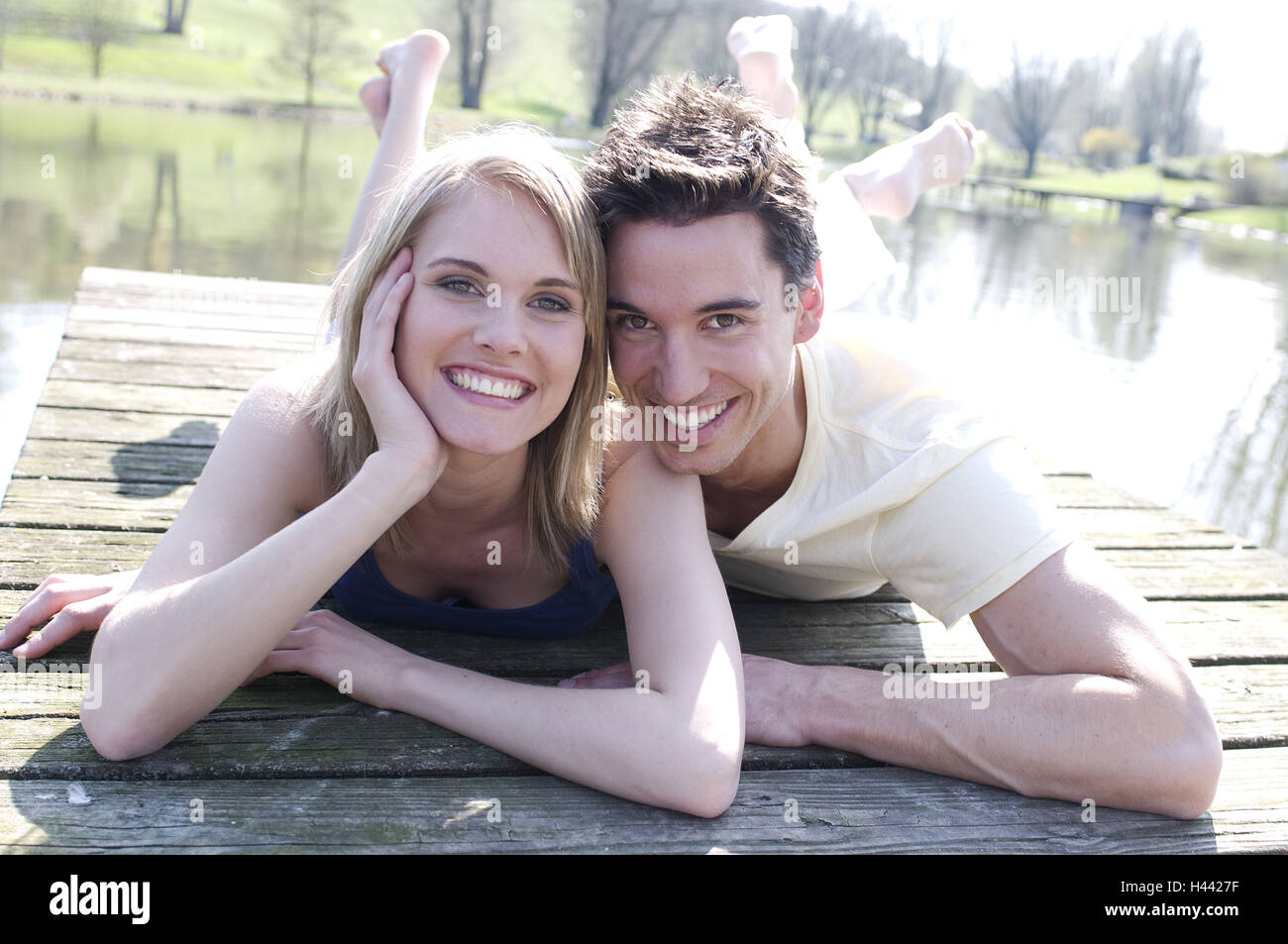 Couple, young, lying, wooden jetty, smile, Stock Photo
