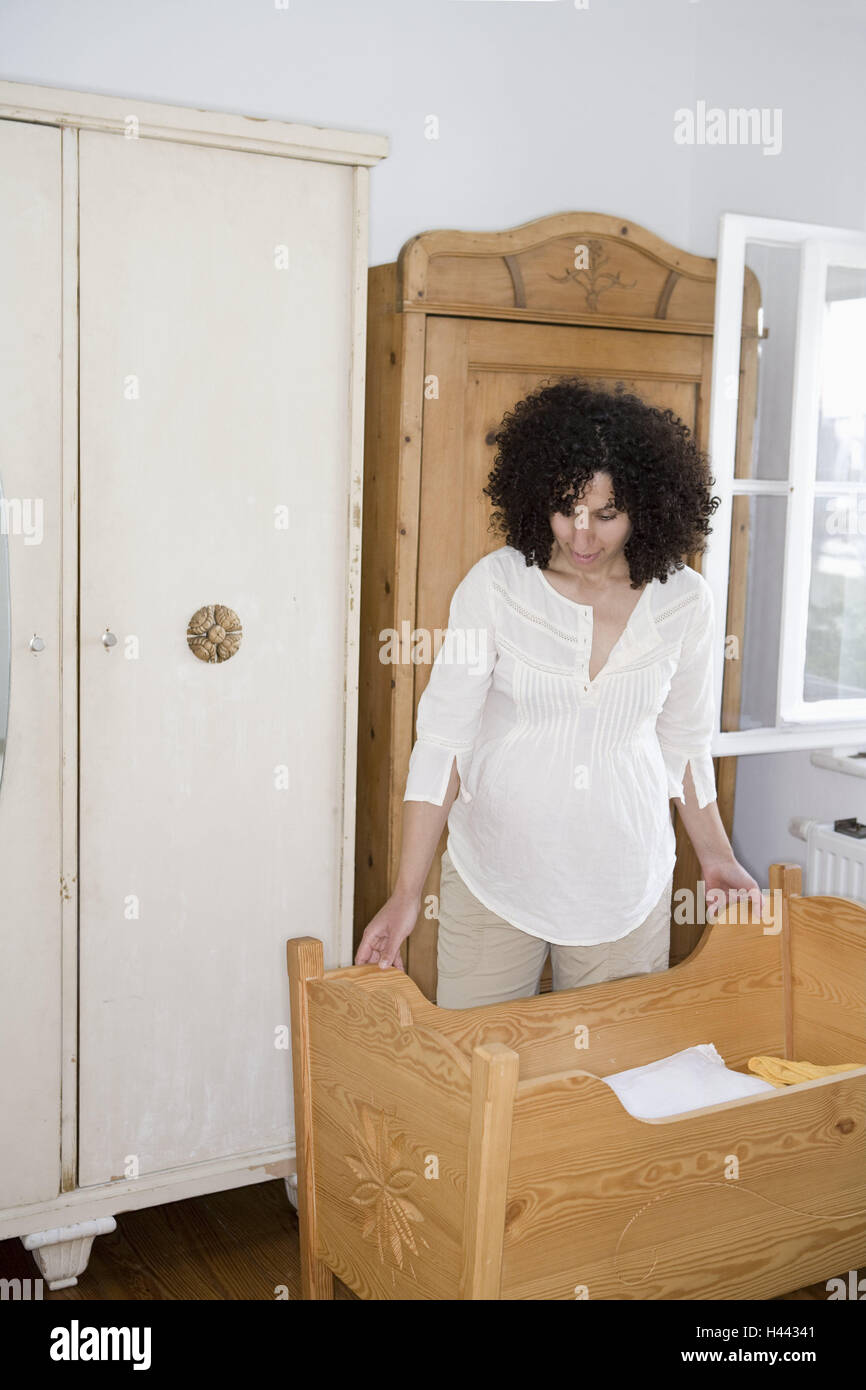 Woman, young, pregnant, bedrooms, stand, cradle, prepares, model released, Stock Photo