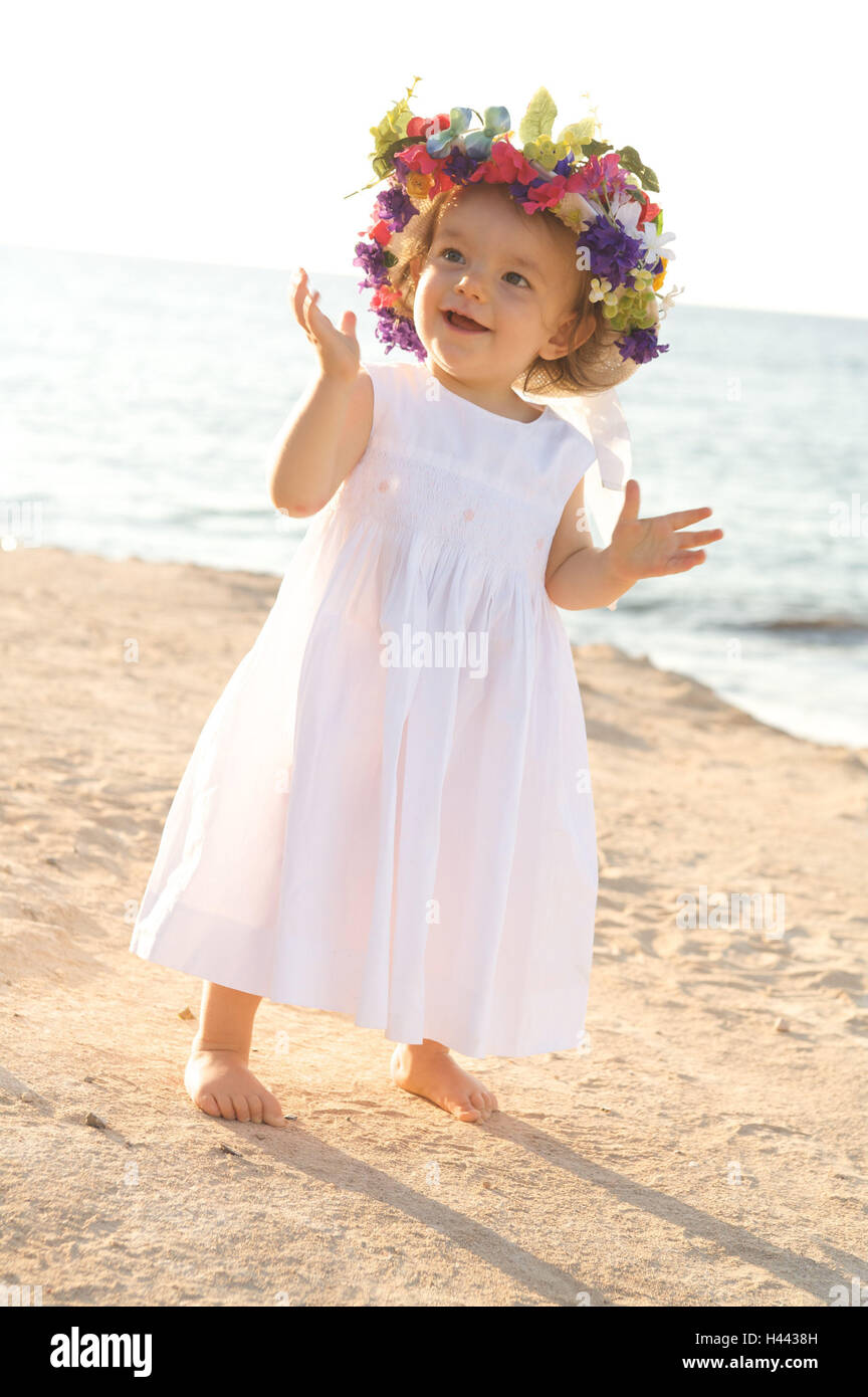 Girls, dress, flower hat, beach, stand, smile, radiate child, infant, summer, the sun, sunny, happy, childhood, lighthearted, fun, openly, course, brightly, sunny, vacation, Sand, sea, care, flowers, floral wreath, brightly, summer dress, motion, bang, jo Stock Photo