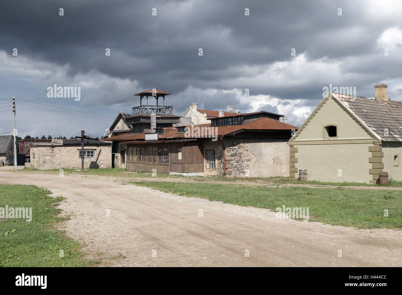 Movie town, Cinevilla, houses, watch-tower, path, lawn, power poles, sky, clouds, north east Europe, Baltic States, Latvia, Tukums, Slampe, Stock Photo