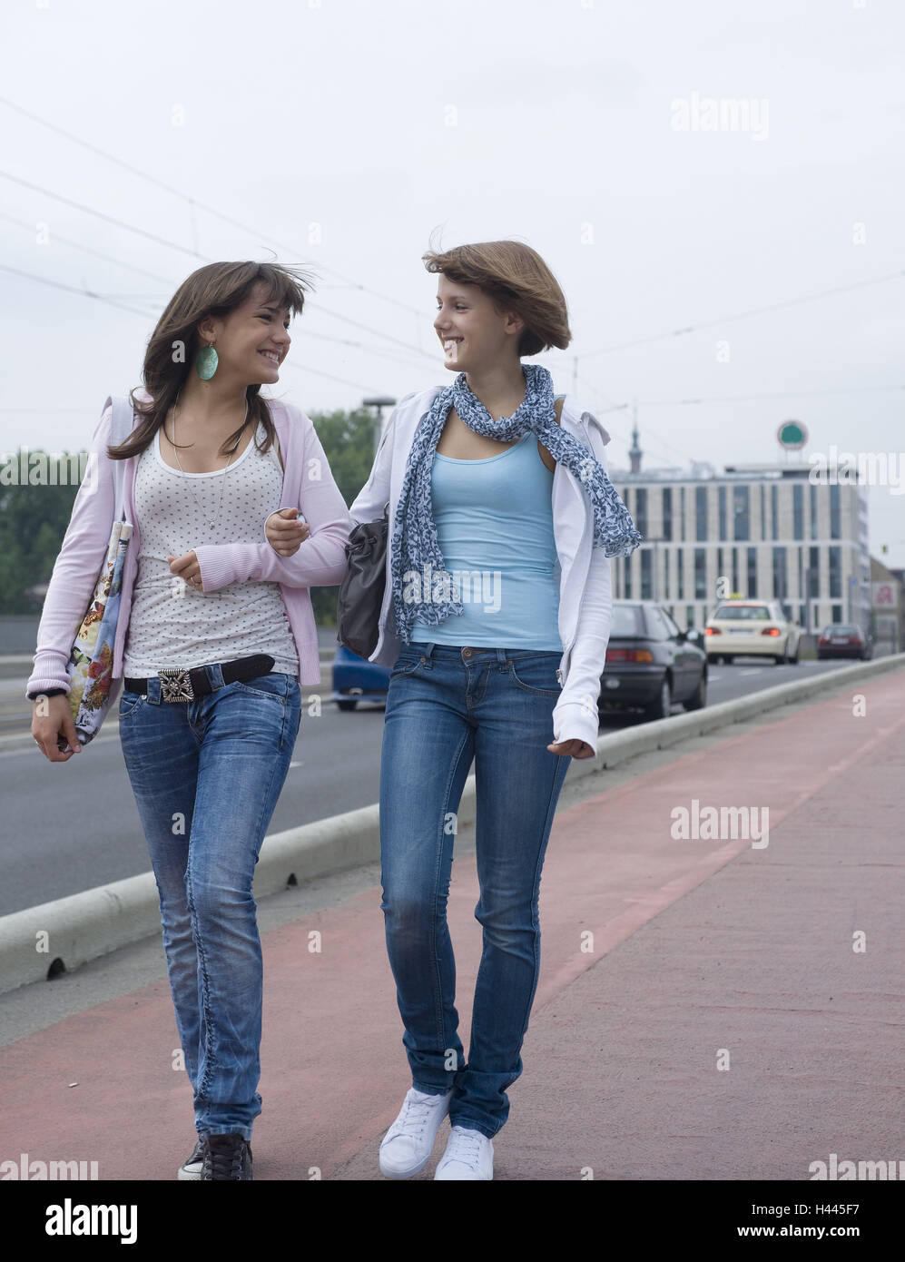 Two Girls Arm In Arm Walk Maintain Stock Photo Alamy