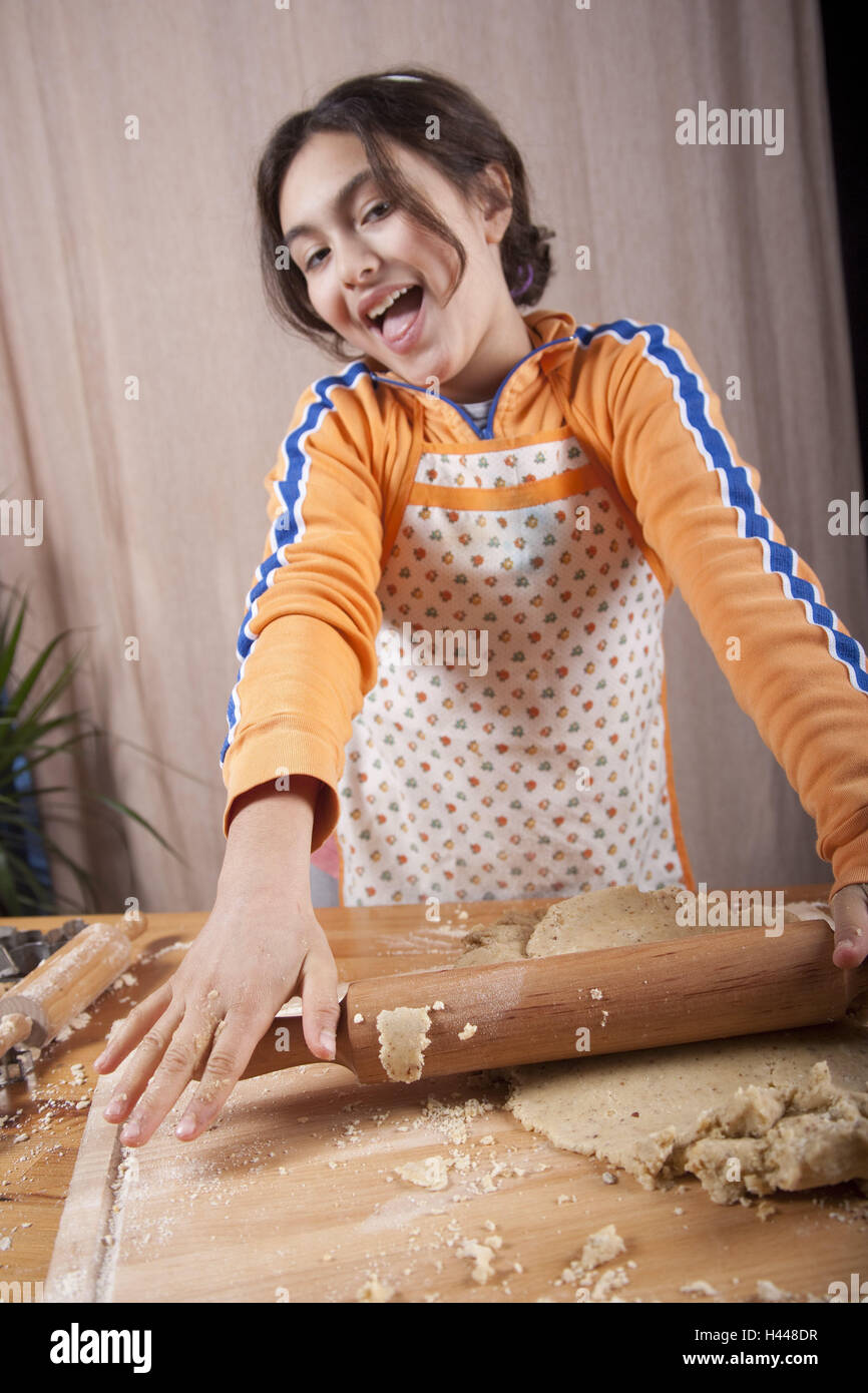 Girls, dough, roll out, people, child, smile, bake proudly, cake, dough scooter, wooden scooter, scroll, joy, apron, cooking apron, Stock Photo