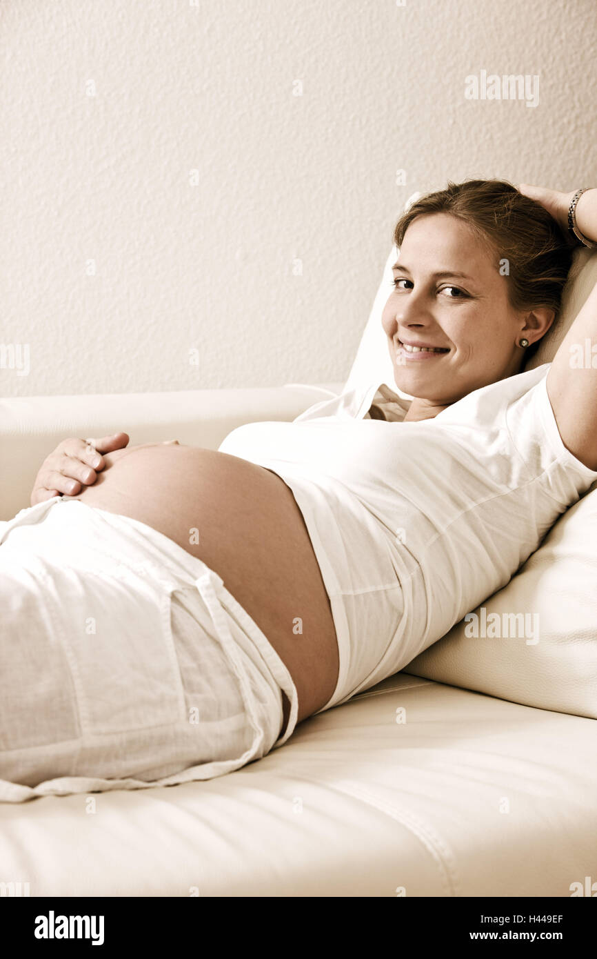 Woman, lie pregnant, sofa, recreation Stock Photo Alamy