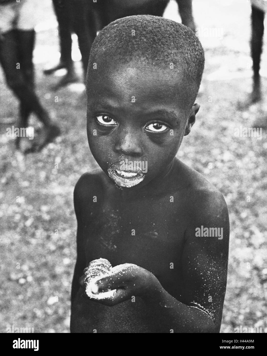 Dahomey, 1962, Child, flour, food, portrait, West Africa, Africa, Benin, people, dark-skinned, African, Coloured, Africans, misery, poverty, hunger, starvation, lack of food, malnourished, victims, helplessness, famine, despair, outside, Stock Photo