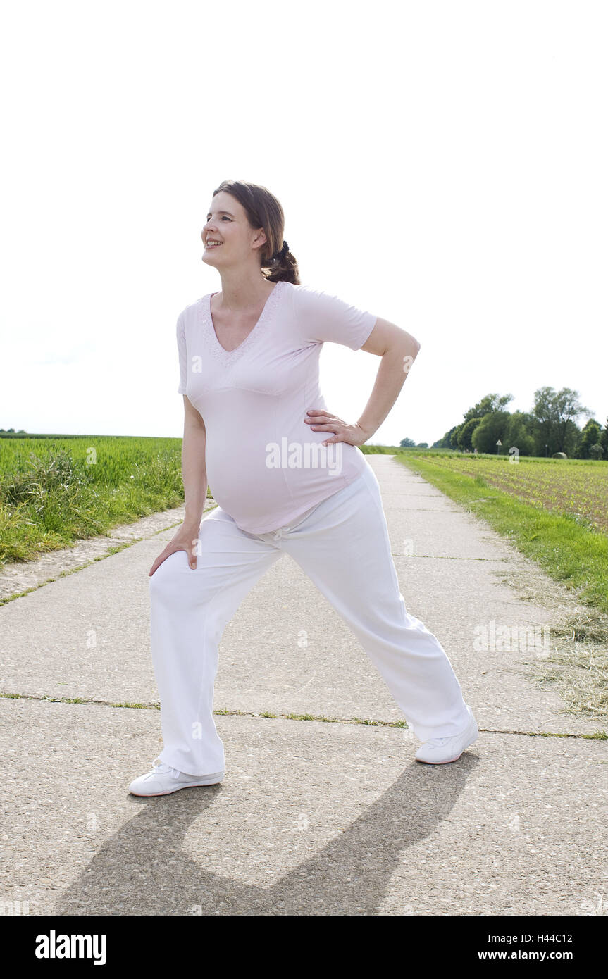 Woman, pregnant, gymnastics practise, outside Stock Photo Alamy