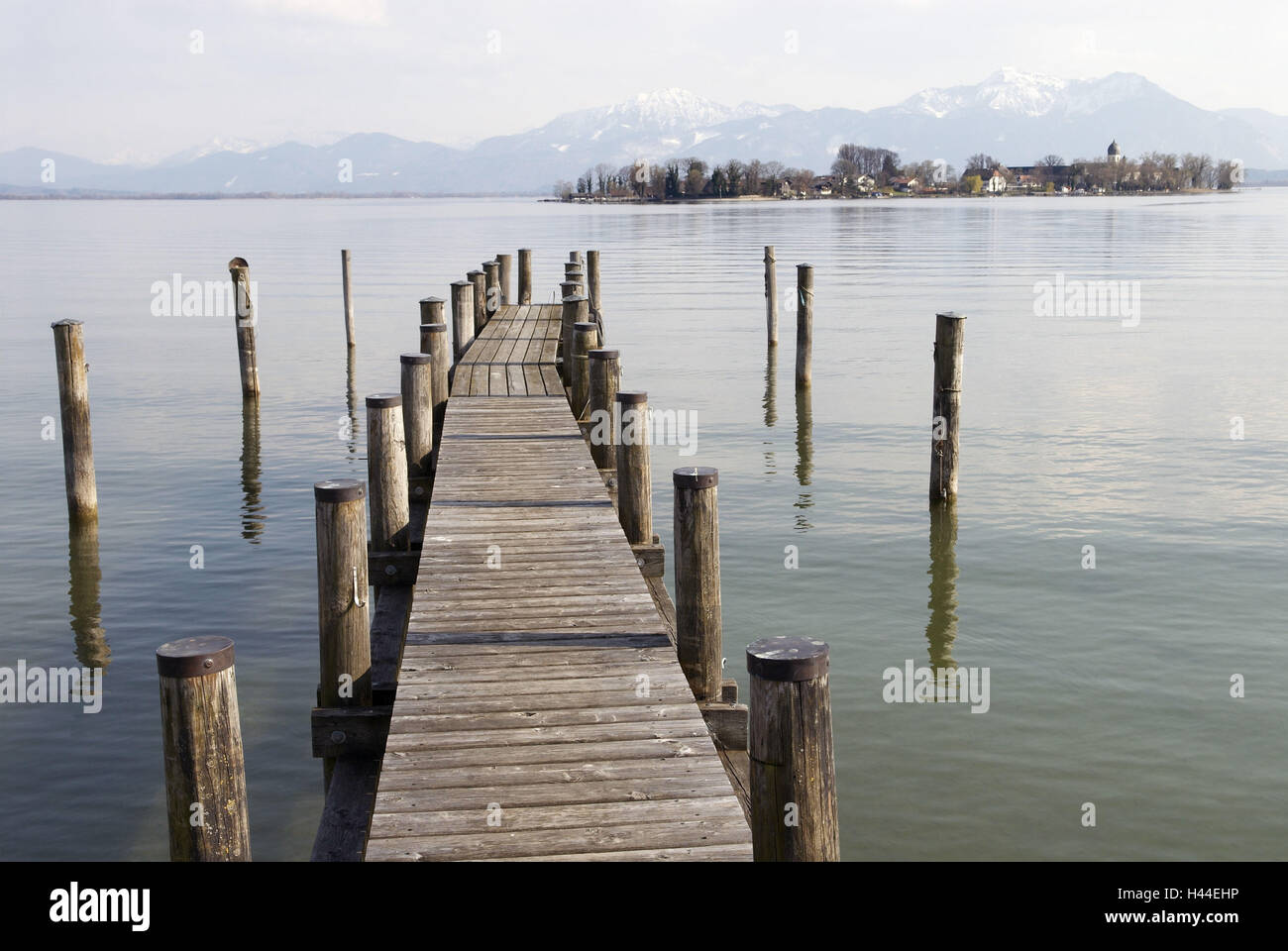 Chiemsee, landing stage, water, reflection, Fraueninsel, houses, church, trees, mountains, sky, clouds, Germany, Bavaria, Chiemgau, Stock Photo