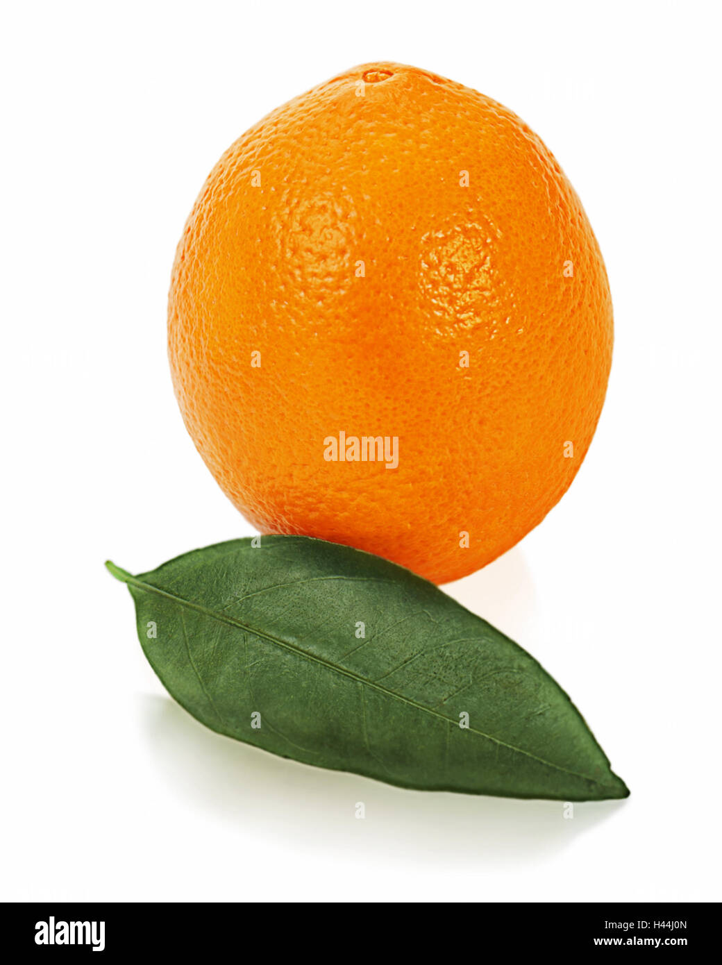 Ripe orange fruit with leaves isolated on white background. Stock Photo
