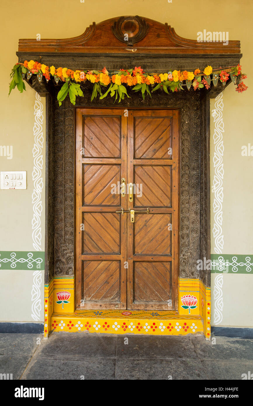 Painted entrance door of traditional Indian home with flowers and Stock