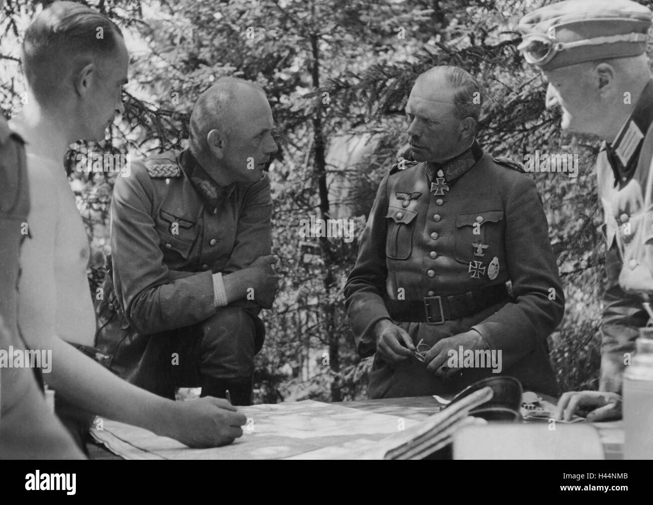 World War, Eastern Front, General Guderian, briefing, War, Military, Nazism, Wehrmacht army, warfare, men, commanders, maps, map, plan, talk, discussion, consultation, planning, 1944 Forest, exterior, historic, Stock Photo