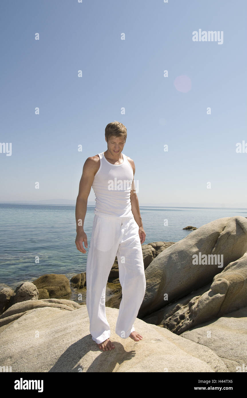 Man, young, leisurewear, white, rocks, sea, Stock Photo