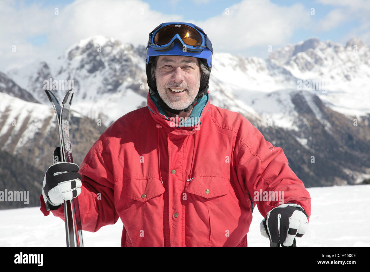 Italy, the Dolomites, Fassatal, senior, ski helmet, view camera, smile